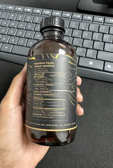 7 Seeds Black Seed Oil glass bottle on wooden kitchen surface