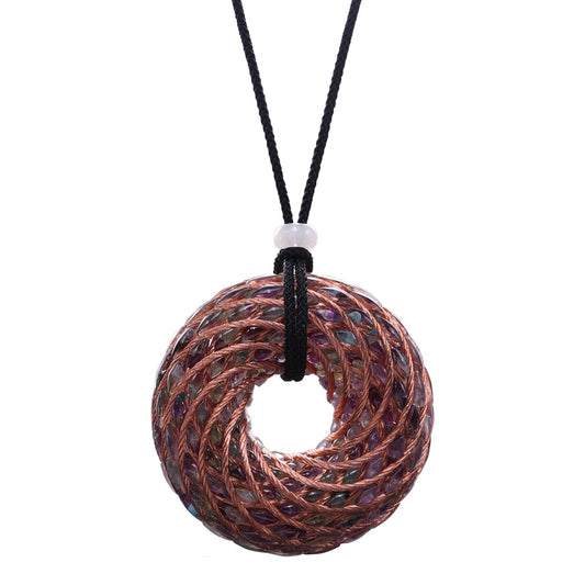 Abrakadoubra tensor rings pendant close-up showing copper double vortex for energy balance.