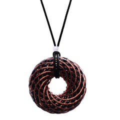 Abrakadoubra tensor rings pendant with copper double vortex and crystal inlay for chakra balance.