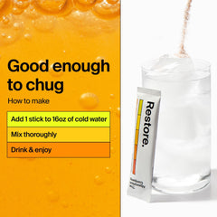 The Absorption Company mango lemonade packet in a glass of water ready to drink