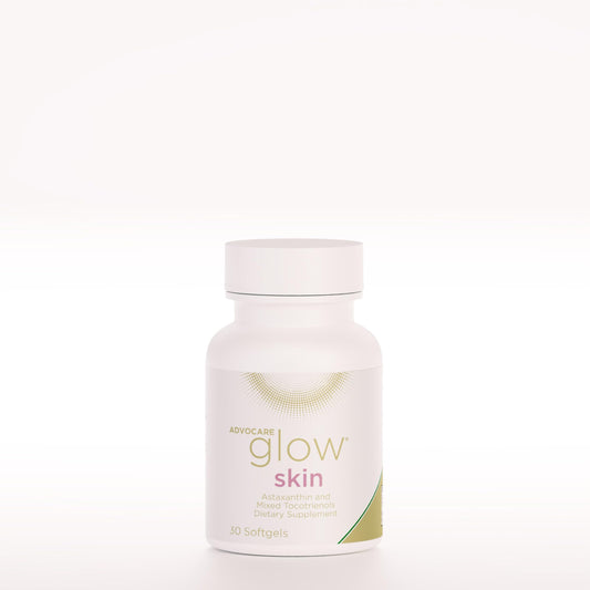 AdvoCare Glow Skin softgel bottle on vanity promoting radiant skin through antioxidant support.