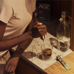 AG1 AGZ Sleep Drink being stirred into a warm mug for night routine.