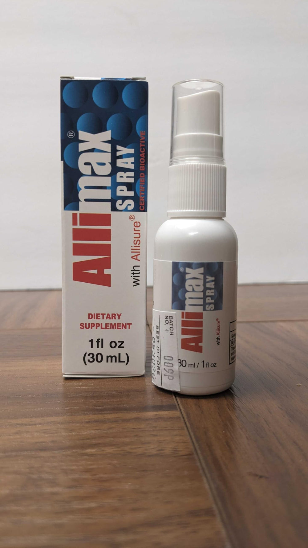 A user applying Allimax Rescue Spray to mouth and throat