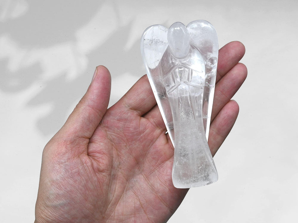Amazing Gemstone Clear Quartz Angel facets catching light for decorative charm.