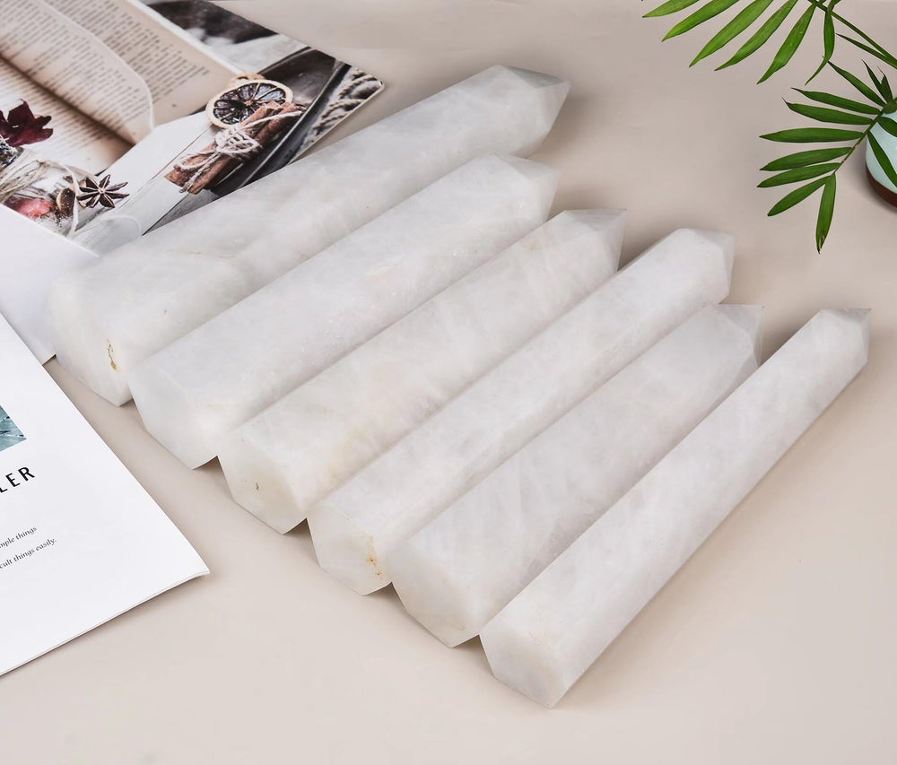 AMOYSTONE white crystal wand displayed as an obelisk in a spa-like setting