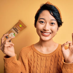 Amrita Nut Free Apple Cinnamon bar near gym bottle suggests plant-based protein option.