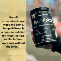 Anabolic Warfare Pump-N-Grow beside a glass of water for pre-workout use.