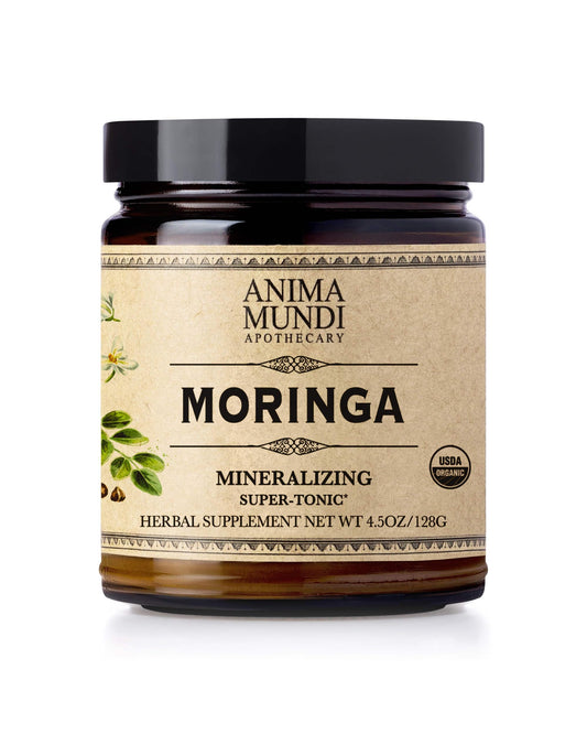 Anima Mundi Moringa Leaf Powder bottle on wood surface signaling natural energy support