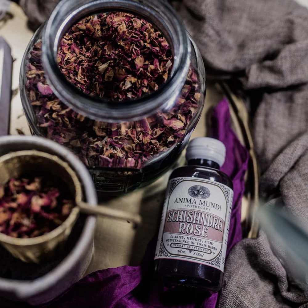 Pouring Anima Mundi Schisandra Rose Elixir into a glass for tea