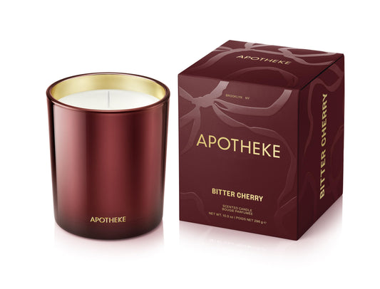 APOTHEKE Bitter Cherry candle in a red jar creates a warm, inviting space.