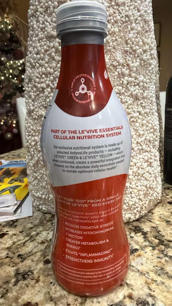 Ardyss Le’Vive Red bottle close-up reveals fresh ingredients and vibrant color