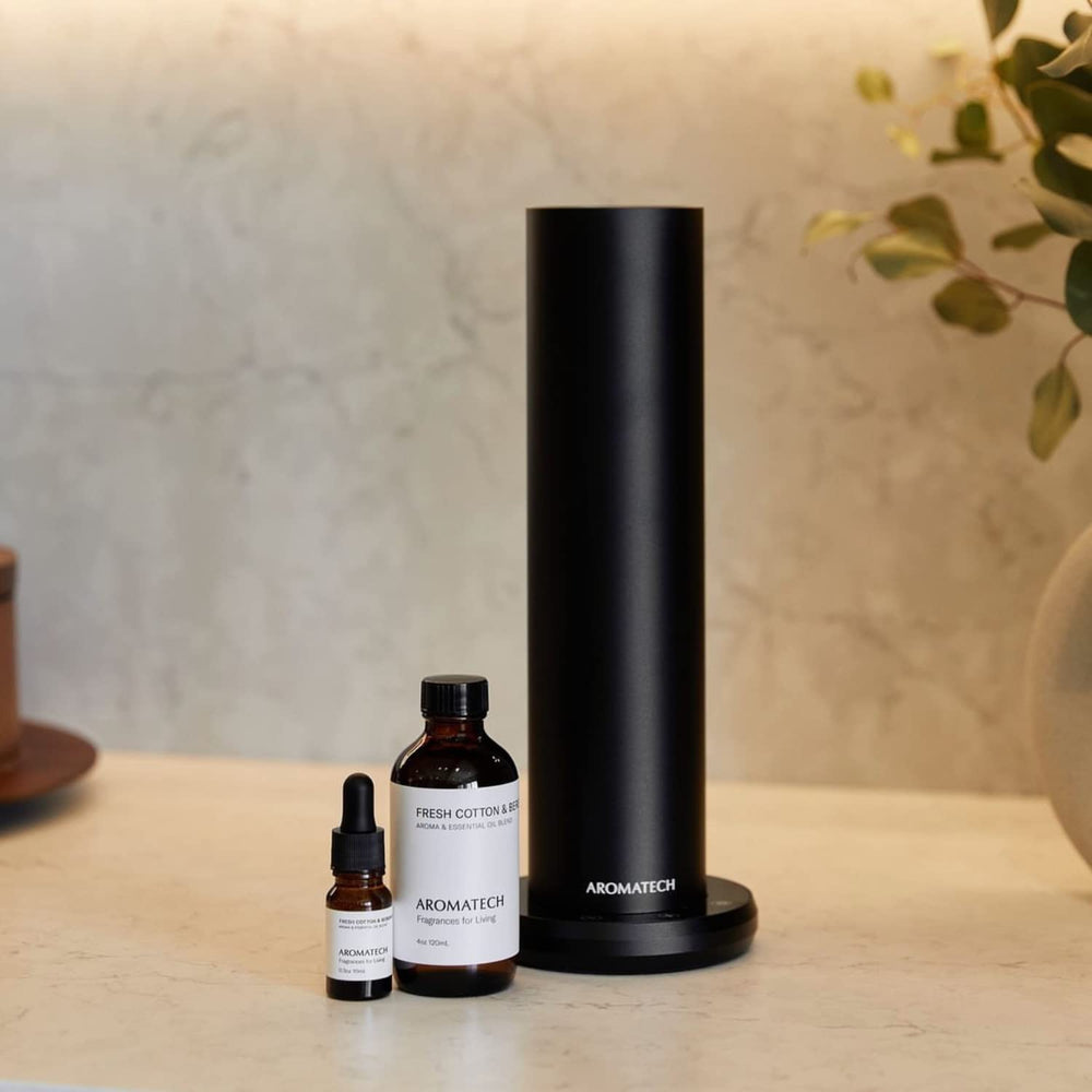Diffuser mist with Aromatech Fresh Cotton & Bergamot in a modern living room.