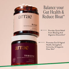 Arrae Bloat capsules on table with fresh citrus nearby.