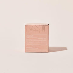 Arrae Calm bottle beside herbal tea for daytime or nighttime use