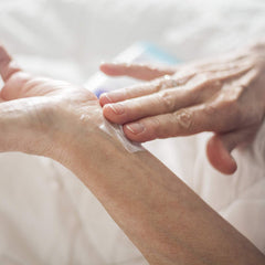 Applying Arthritis Wonder cream to a hand demonstrates easy massage and absorption.