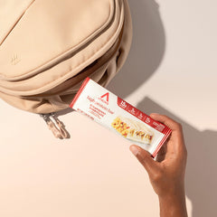 Athlete holding Atkins bar after workout for quick fuel