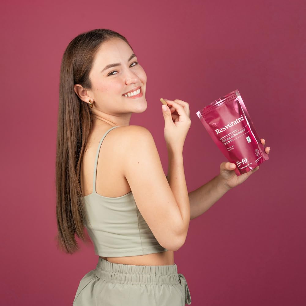 Glass of water beside B-FIT B Resveratrol bottle, ready for daily use.