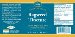 Dropping Baar Ragweed Tincture into a drink for liver support.