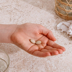 Measuring spoon with Banyan Botanicals Mucuna Pruriens tablets for easy dosing.