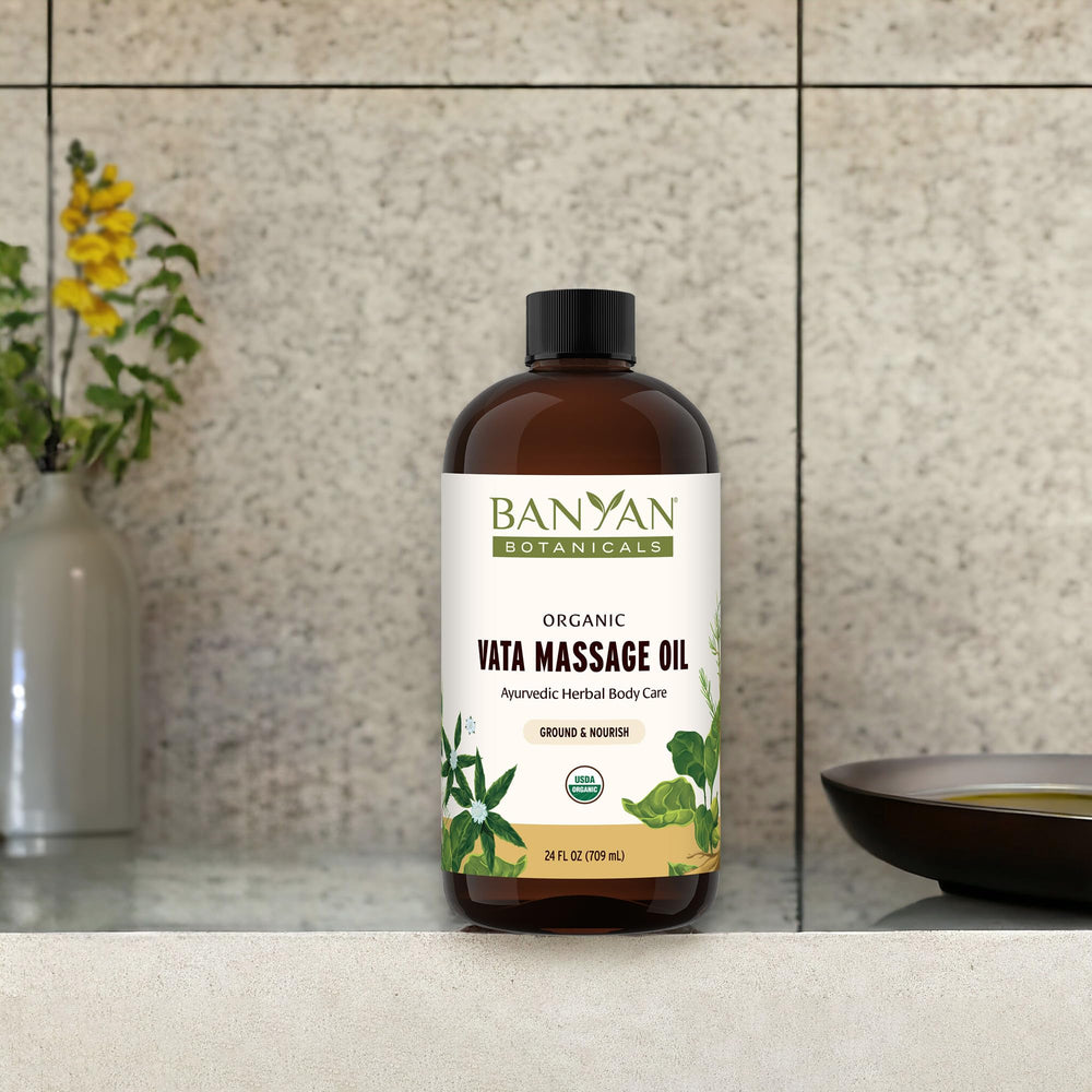 Banyan Botanicals Vata Massage Oil bottle being poured for use