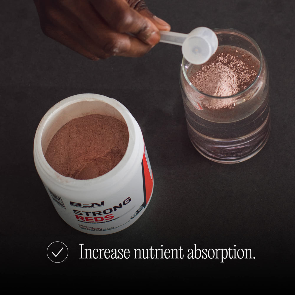 Bare Performance Nutrition Strong Reds powder dispersing in liquid for natural energy.