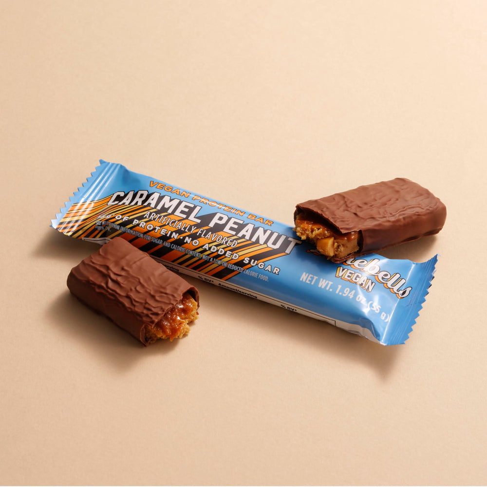 Barebells vegan peanut caramel bar breakfast option on kitchen counter.