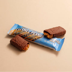 Barebells vegan peanut caramel bar breakfast option on kitchen counter.