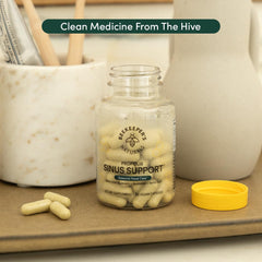 Beekeeper's Naturals propolis honeycomb jar on wooden surface.