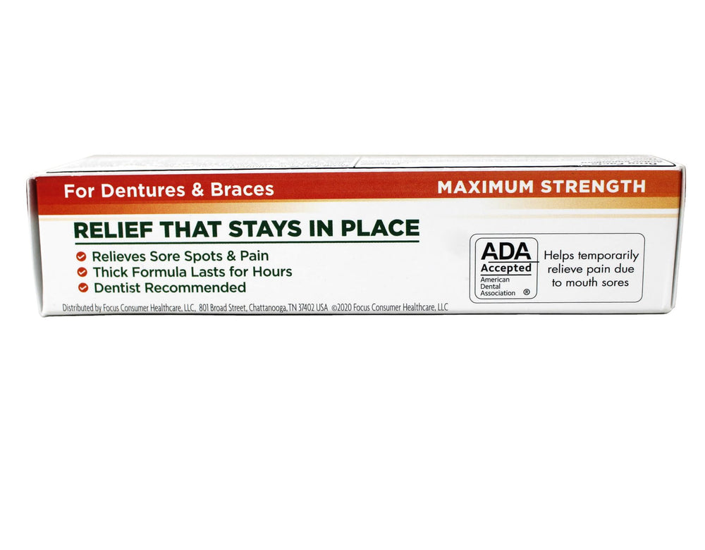 Cream's thick consistency seen adhering to gums for extended relief