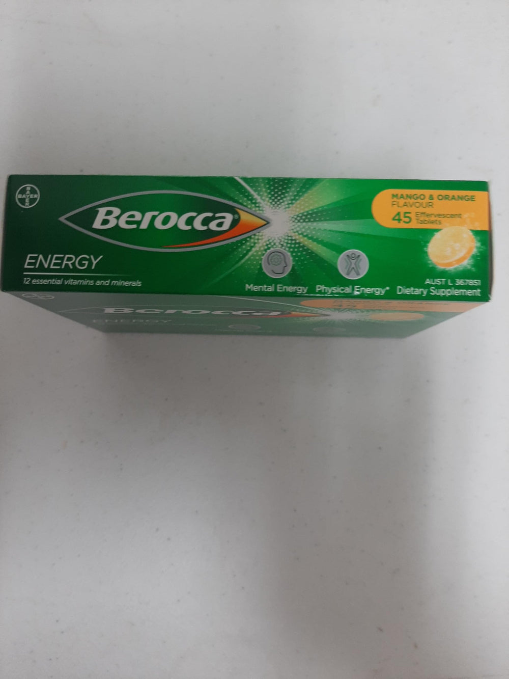 Berocca Energy mango-orange in a glass of water, ready to dissolve.