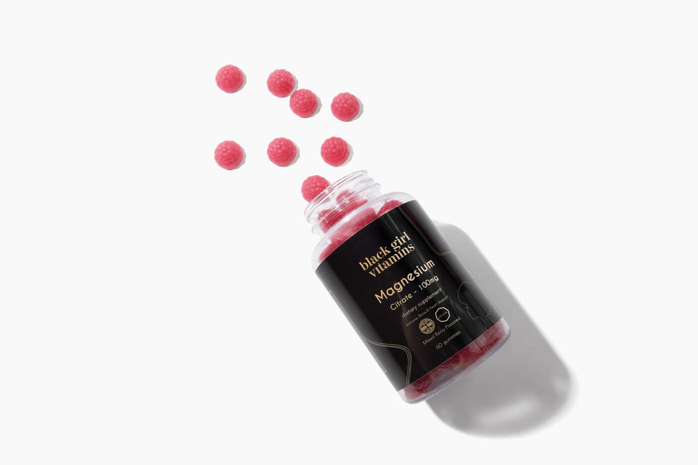 Lifestyle image of Black Girl Vitamins magnesium gummies on a nightstand setup.