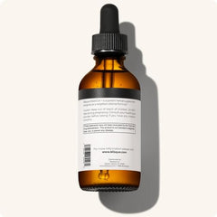 Bottle of Blisque PARATOX+ beside a glass of water