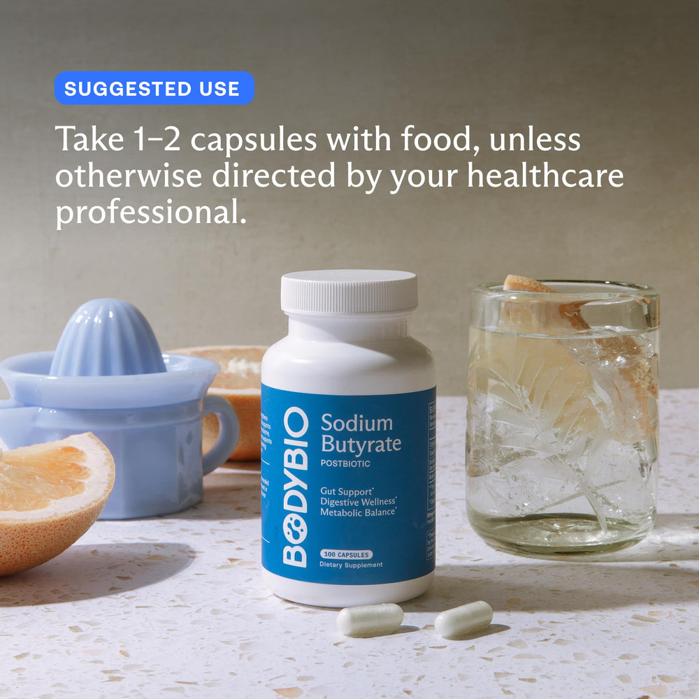 BodyBio Butyrate capsules poured for easy daily intake with water.