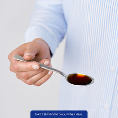 Bottle on kitchen counter with dosing spoon for easy measurement.