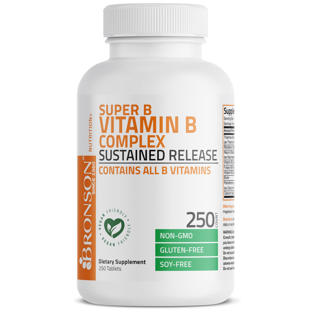 Bronson Super B Complex glass with tablets and water on table.