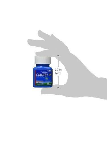 Adult takes a Claritin tablet with water for all-day relief.