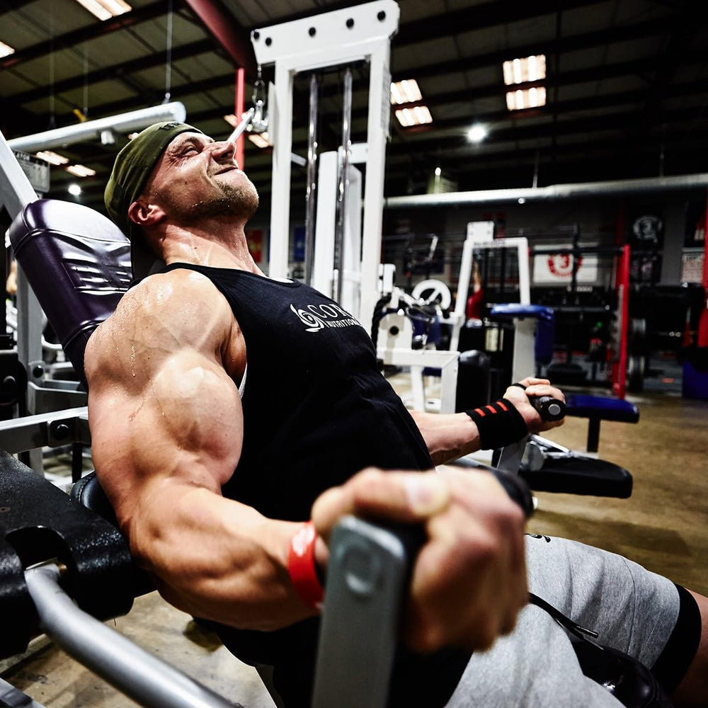 Core Nutritionals Grow Mass scoop beside powder for easy daily fueling.