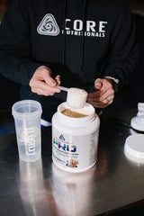 Core Nutritionals scoop beside powder, easy to measure and mix