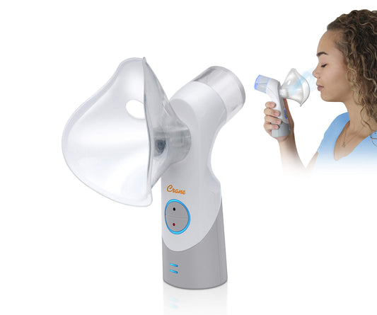 Crane EE-5948 cordless inhaler held in hand for on-the-go mist therapy.