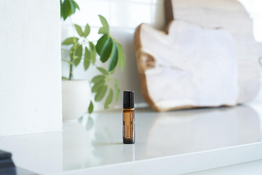 doTERRA Vetiver Touch roll-on application on skin for calming routine.