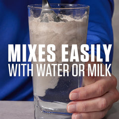 Pouring vanilla mass gainer to create a ready-to-drink shake
