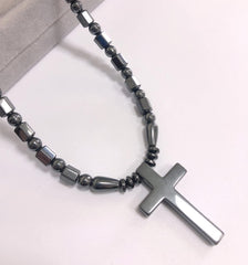 Ecooon cross pendant magnetic closure shown securing the necklace during activity.
