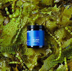 eimele Optimal Omega+ daily-use scene with water and capsules for wellness.