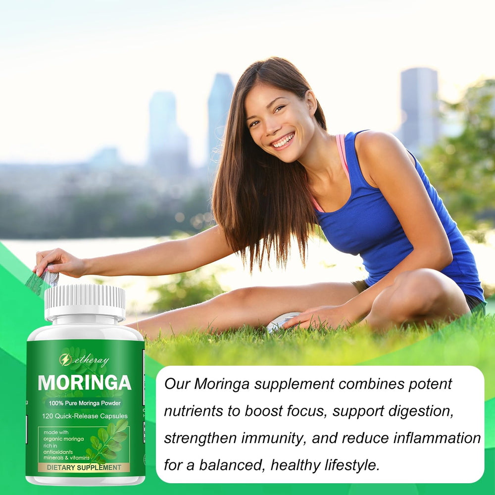 Hand holding Etheray Moringa Capsules bottle for travel use