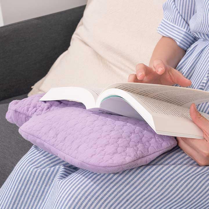 Fashy hot water bottle in use as a warm compress for comfort.