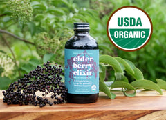 Fields Without Fences Elderberry Elixir bottle in a family kitchen, signaling kid-friendly daily use.