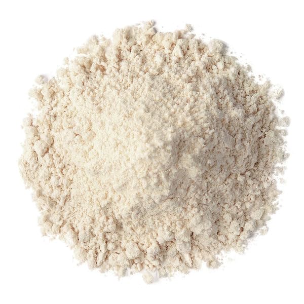 Food to Live almond protein powder in smoothie cup, ready to blend.