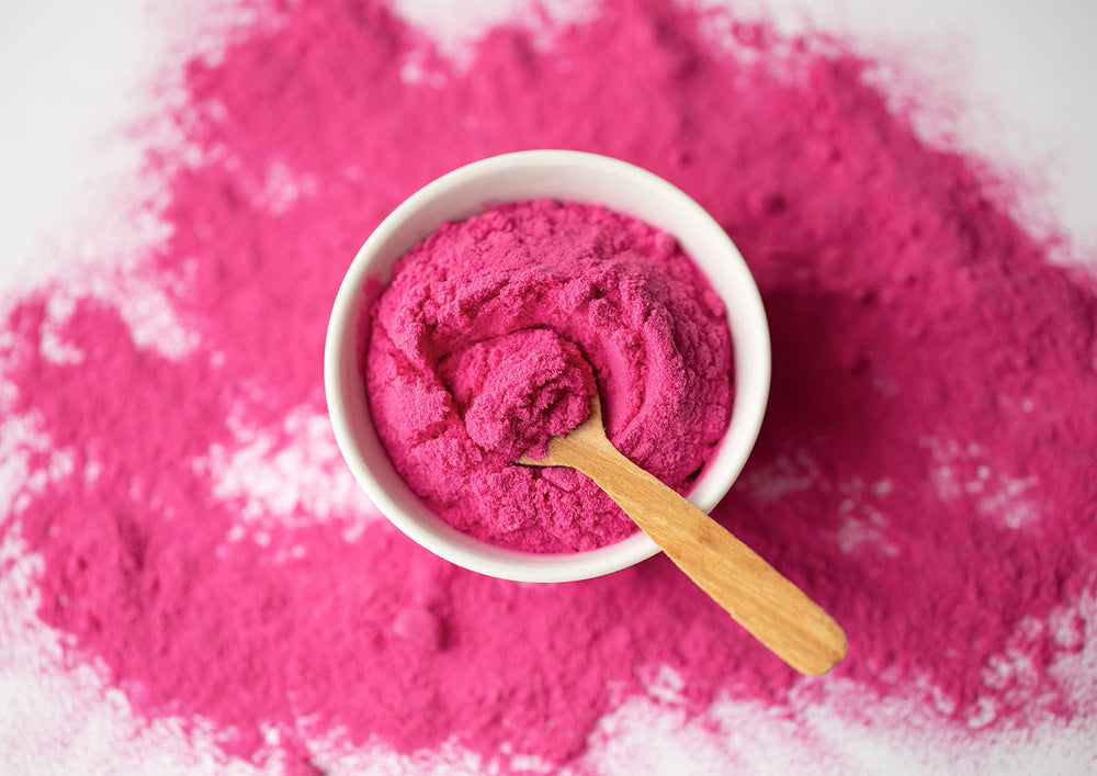 Shaker with Food to Live Dragon Fruit Powder, blends easily into beverages.