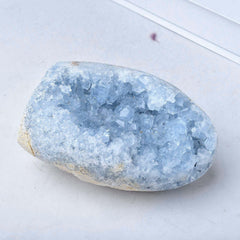 FZBHRO sky-blue celestite geode in a cozy reading nook