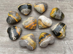 GAF Treasures Bumble Bee Jasper palm stone held in hand for grounding energy